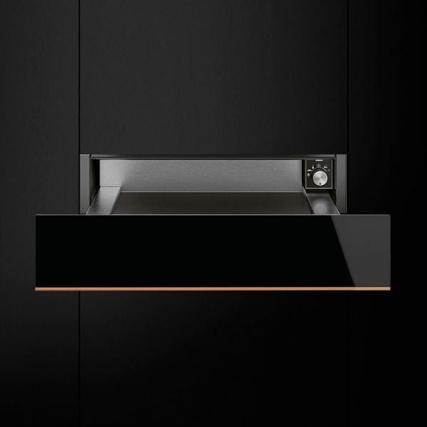 Open black kitchen drawer with metal accents