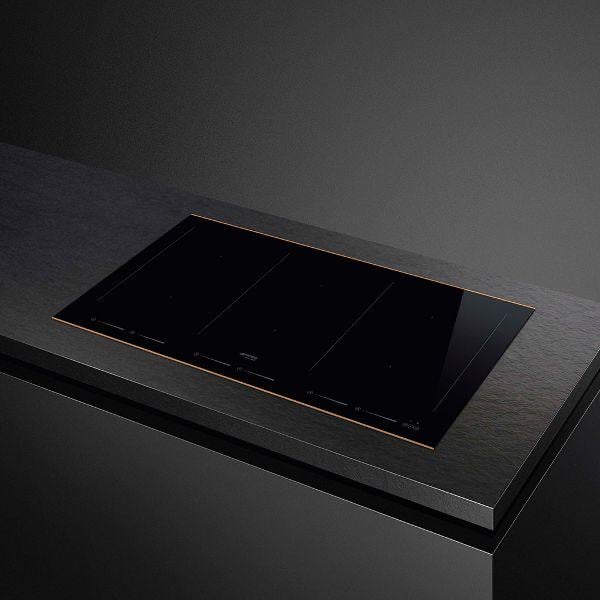 Black induction cooktop with three cooking zones