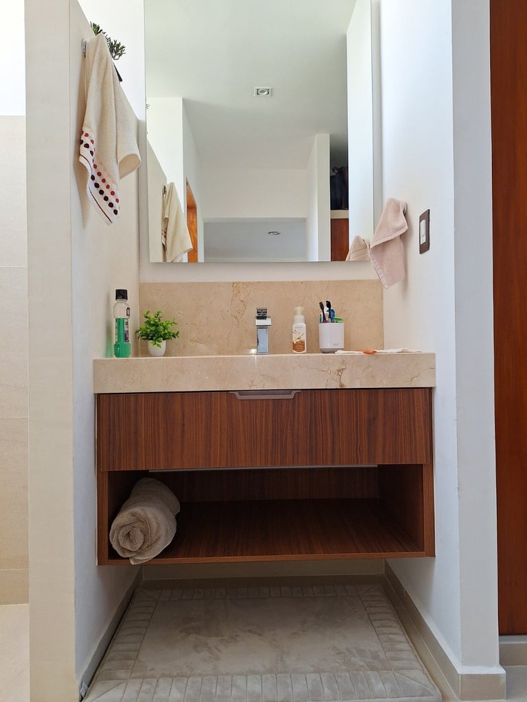 Modern bathroom with floating wood vanity, stone countertop, large mirror, and open shelving below sink