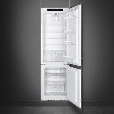 Open white built-in refrigerator with empty shelves